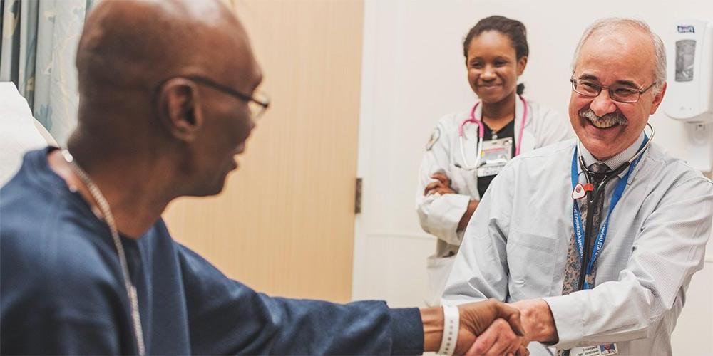 Dr. Stephen Graziano, medical oncologist, greets a patient. Upstate Medical Oncology treats cancer and other hematologic conditions with infusions including chemotherapy in Syracuse, Oneida and Oswego.