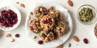 Peanut butter balls garnished with almonds, pepitas and dried cranberries.