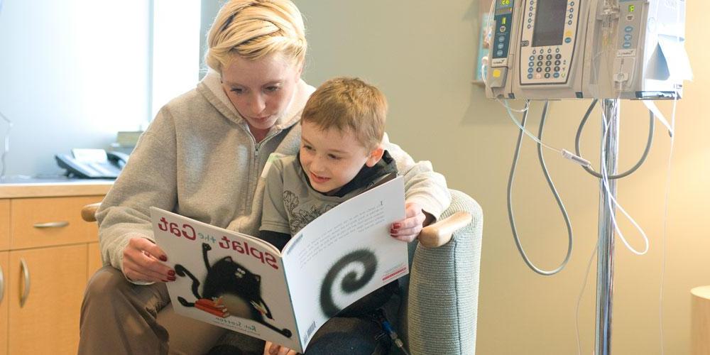 mother reading to son in family resource center